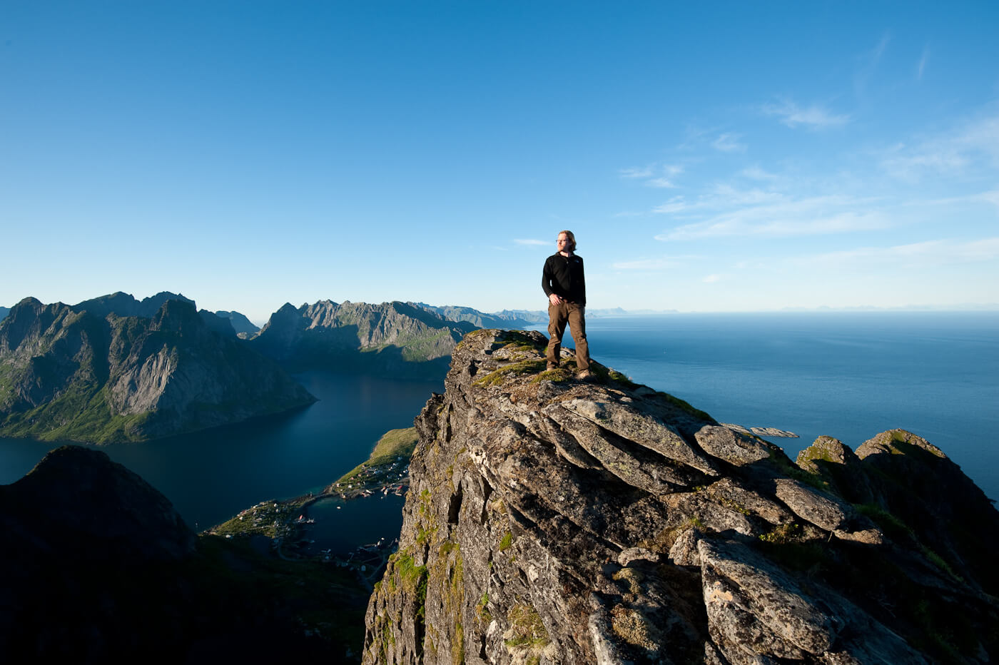 A photo of me walking along a ridge overlooking a line of mountainous islands in the ocean